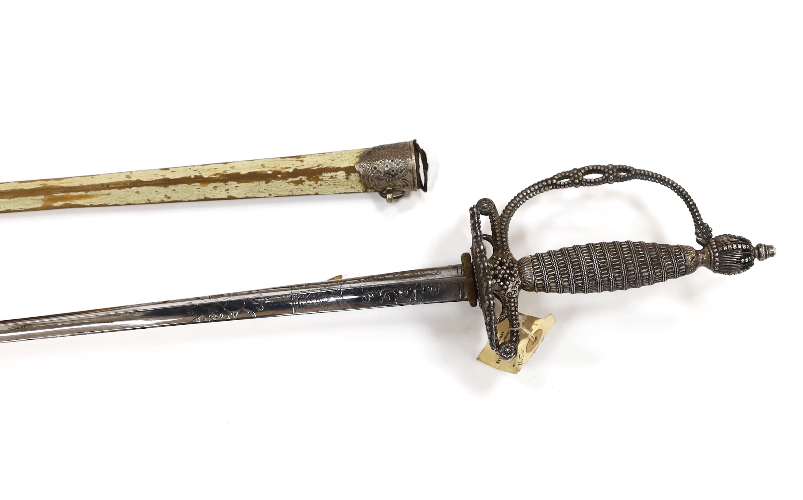 An English small sword, c.1775, pierced with facetted stud work, silver tape and wire bound grip, triangular section etched blade, in its original vellum scabbard and silver mounts, top mount engraved Dieltry Royal Excha